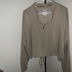 Cinched bottom three quarter zip